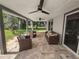 Covered patio with wicker furniture and lake view at 5252 Post Ln, Lakeland, FL 33809