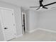Spacious bedroom with ceiling fan and access to bathroom at 5252 Post Ln, Lakeland, FL 33809