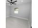 Well-lit bedroom featuring a ceiling fan and window at 5252 Post Ln, Lakeland, FL 33809
