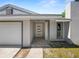 Modern front door with gray and white color scheme and stone flooring at 5252 Post Ln, Lakeland, FL 33809