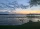 Peaceful lakefront view at sunset, featuring a gazebo at 5252 Post Ln, Lakeland, FL 33809