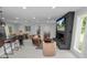 Open-concept living room with fireplace, large TV, and stylish seating at 5252 Post Ln, Lakeland, FL 33809
