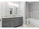 Gray vanity, granite countertop, and tiled shower/tub combo at 5272 Riverlake Dr, Bartow, FL 33830