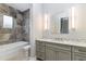 Bathroom with tiled shower, granite countertop, and modern vanity at 5272 Riverlake Dr, Bartow, FL 33830