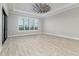 Bright bedroom featuring wood-look tile flooring and plantation shutters at 5272 Riverlake Dr, Bartow, FL 33830