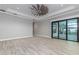 Primary bedroom with sliding glass doors to backyard and ceiling fan at 5272 Riverlake Dr, Bartow, FL 33830