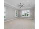 Spacious bedroom with carpeting, ceiling fan, and large windows at 5272 Riverlake Dr, Bartow, FL 33830