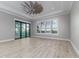 Spacious bedroom with wood-look tile floors and sliding glass doors at 5272 Riverlake Dr, Bartow, FL 33830