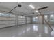 Spacious three-car garage with epoxy flooring and attic access at 5272 Riverlake Dr, Bartow, FL 33830