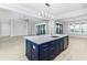 Blue kitchen island with granite countertop and stainless steel sink at 5272 Riverlake Dr, Bartow, FL 33830