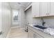Laundry room with granite countertop and farmhouse sink at 5272 Riverlake Dr, Bartow, FL 33830