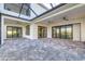 Covered patio with paver stones and multiple sliding glass doors at 5272 Riverlake Dr, Bartow, FL 33830