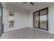 Spacious screened balcony with wood-look tile flooring at 5272 Riverlake Dr, Bartow, FL 33830