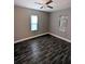 Spacious bedroom with gray walls and wood-look floors at 612 Lemon St, Auburndale, FL 33823