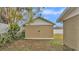 Tan colored garage with double doors in the backyard at 616 W Remington Rd, Lakeland, FL 33813