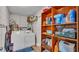 Functional laundry room with washer, dryer, and shelving at 616 W Remington Rd, Lakeland, FL 33813