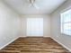 Well-lit bedroom with laminate wood flooring and double-door closet at 646 Cottage Ln, Lakeland, FL 33803