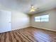 Bright bedroom with wood-look floors and ceiling fan at 646 Cottage Ln, Lakeland, FL 33803