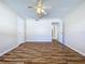 Bright bedroom with wood-look floors and access to hallway at 646 Cottage Ln, Lakeland, FL 33803