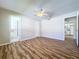 Bright bedroom with wood-look floors and access to kitchen at 646 Cottage Ln, Lakeland, FL 33803