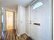 Entryway with white door, storage closet, and hardwood floors at 646 Cottage Ln, Lakeland, FL 33803
