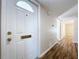 Interior view of entryway with white door and wood flooring at 646 Cottage Ln, Lakeland, FL 33803