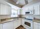 Kitchen with white cabinets, granite countertops, and modern appliances at 646 Cottage Ln, Lakeland, FL 33803
