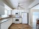 Kitchen with white cabinets, granite countertops, and modern appliances at 646 Cottage Ln, Lakeland, FL 33803