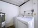 Laundry area with washer, dryer, and water heater at 646 Cottage Ln, Lakeland, FL 33803