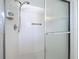 Shower stall with glass door and tiled walls at 646 Cottage Ln, Lakeland, FL 33803