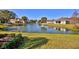 Landscaped backyard with pond and view of neighboring homes at 6555 Lake Clark Dr, Lakeland, FL 33813