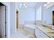 Spa-like bathroom with soaking tub and granite countertops at 6555 Lake Clark Dr, Lakeland, FL 33813