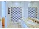 Bathroom with granite countertop, white cabinets and shower/tub combo at 6555 Lake Clark Dr, Lakeland, FL 33813