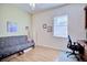 Versatile bedroom with a sleeper sofa, home office setup, and hardwood floors at 6555 Lake Clark Dr, Lakeland, FL 33813
