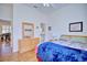 Spacious bedroom with hardwood floors, dresser, and a view into another room at 6555 Lake Clark Dr, Lakeland, FL 33813