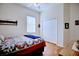 Bright bedroom with hardwood floors, a queen bed, and a double door closet at 6555 Lake Clark Dr, Lakeland, FL 33813