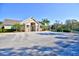 Community clubhouse with stone accents and palm trees at 6555 Lake Clark Dr, Lakeland, FL 33813