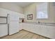 Clean and functional kitchen with white cabinets and appliances at 6555 Lake Clark Dr, Lakeland, FL 33813
