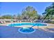 Inviting kidney-shaped pool with a spa and lounge chairs at 6555 Lake Clark Dr, Lakeland, FL 33813
