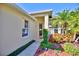 Front entry with walkway, landscaping, and a two-car garage at 6555 Lake Clark Dr, Lakeland, FL 33813