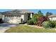 Charming home featuring a two-car garage, complemented by lush landscaping and a well-maintained lawn at 6555 Lake Clark Dr, Lakeland, FL 33813