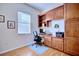 Functional home office with built-in wooden desk and cabinets at 6555 Lake Clark Dr, Lakeland, FL 33813