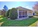 House exterior showcasing a screened porch and landscaped yard at 6555 Lake Clark Dr, Lakeland, FL 33813