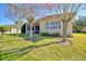 Back exterior of house with screened porch, landscaping, and trees at 6555 Lake Clark Dr, Lakeland, FL 33813