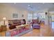 Open living room with hardwood floors, comfortable leather seating, and views of the kitchen at 6555 Lake Clark Dr, Lakeland, FL 33813