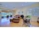 Bright living room featuring hardwood floors, leather sofas, and sliding glass doors leading to the backyard at 6555 Lake Clark Dr, Lakeland, FL 33813