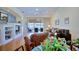 Living room with hardwood floors, leather furniture, and view of backyard patio at 6555 Lake Clark Dr, Lakeland, FL 33813
