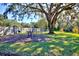 Fenced-in pet park with benches under a large oak tree at 6555 Lake Clark Dr, Lakeland, FL 33813