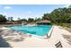 Community swimming pool with lounge chairs and surrounding area at 6611 Sweetbriar Ln, Lakeland, FL 33813