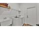 Laundry room with washer, dryer, utility sink, and shelving at 6955 Treymont Dr, Lakeland, FL 33813